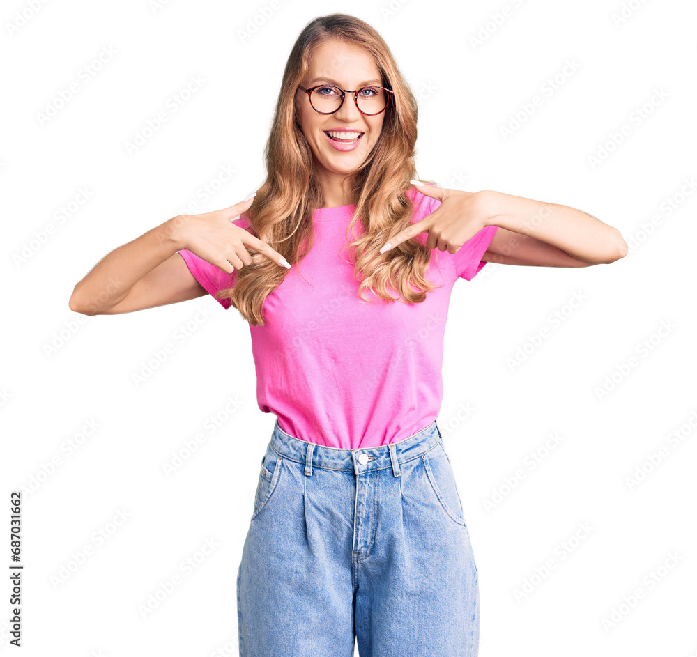 Fototapeta premium Young beautiful caucasian woman with blond hair wearing casual clothes and glasses looking confident with smile on face, pointing oneself with fingers proud and happy.