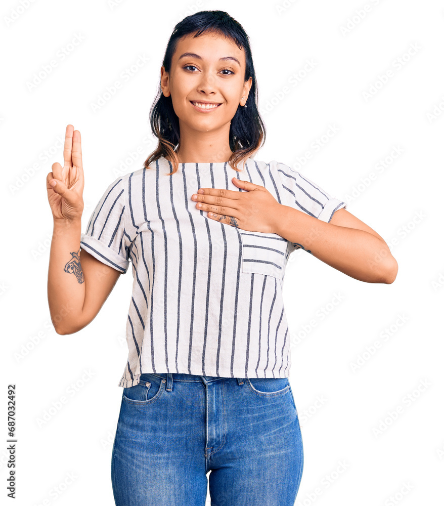 Young woman wearing casual clothes smiling swearing with hand on chest and fingers up, making a loyalty promise oath Young woman wearing casual clothes smiling swearing with hand on chest and fingers up, making a loyalty promise oath