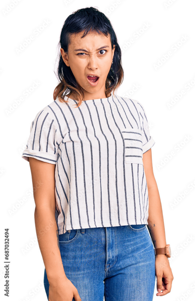 Young woman wearing casual clothes in shock face, looking skeptical and sarcastic, surprised with open mouth Young woman wearing casual clothes in shock face, looking skeptical and sarcastic, surprised with open mouth