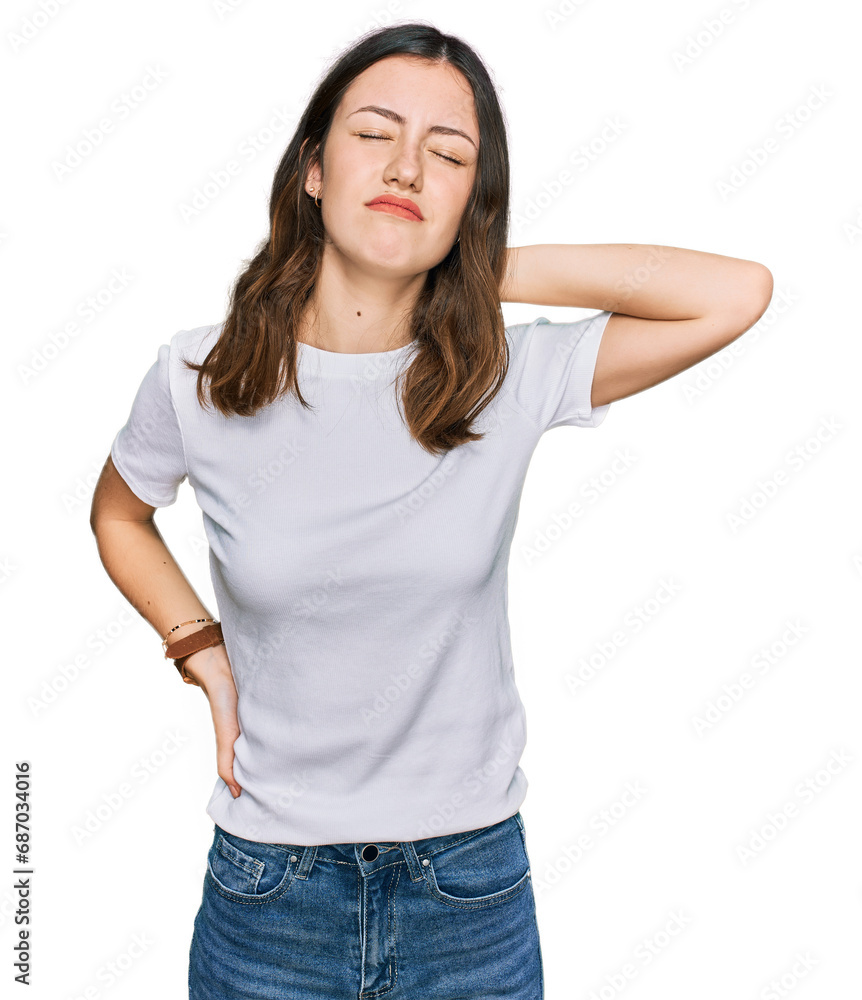 Young beautiful woman wearing casual white t shirt suffering of neck ache injury, touching neck with hand, muscular pain Young beautiful woman wearing casual white t shirt suffering of neck ache injury, touching neck with hand, muscular pain