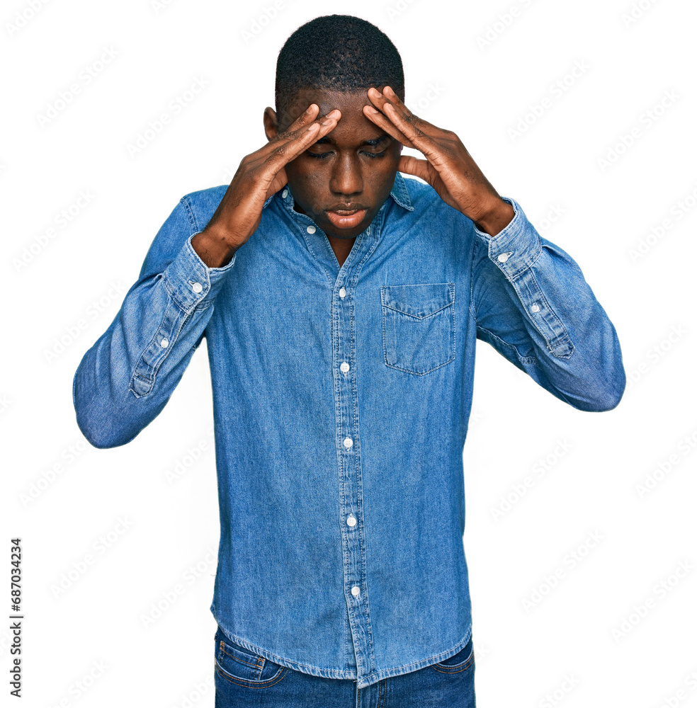 Young african american man wearing casual clothes with hand on head for pain in head because stress. suffering migraine. Young african american man wearing casual clothes with hand on head for pain in head because stress. suffering migraine.