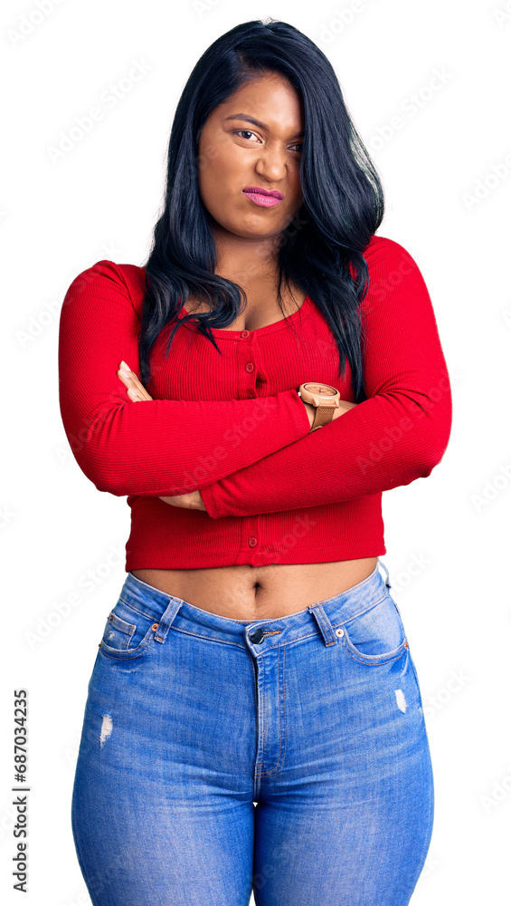 Hispanic woman with long hair wearing casual clothes skeptic and nervous, disapproving expression on face with crossed arms. negative person. Hispanic woman with long hair wearing casual clothes skeptic and nervous, disapproving expression on face with crossed arms. negative person.