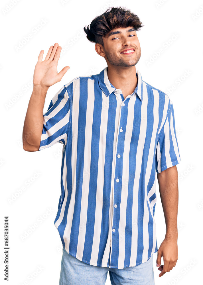 Young hispanic man wearing casual clothes waiving saying hello happy and smiling, friendly welcome gesture Young hispanic man wearing casual clothes waiving saying hello happy and smiling, friendly welcome gesture