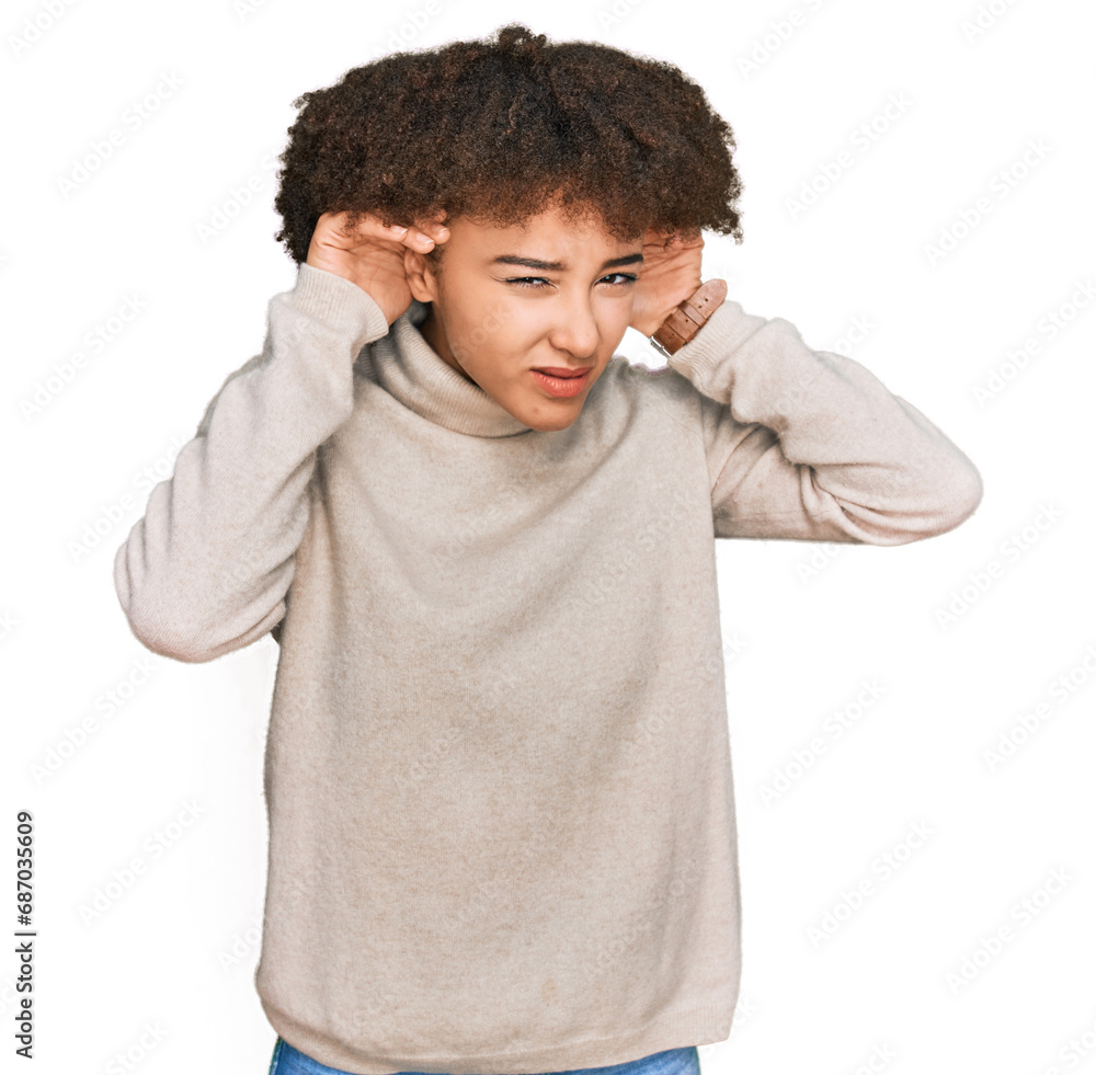 Young hispanic girl wearing wool winter sweater trying to hear both hands on ear gesture, curious for gossip. hearing problem, deaf Young hispanic girl wearing wool winter sweater trying to hear both hands on ear gesture, curious for gossip. hearing problem, deaf