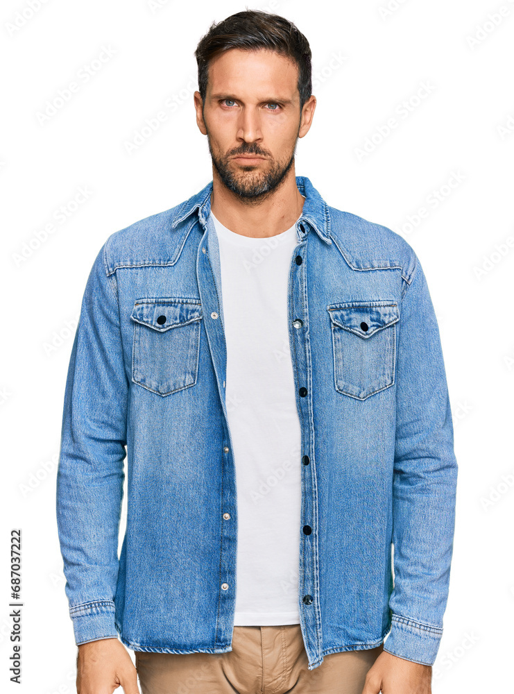 Young handsome man wearing casual denim jacket skeptic and nervous, frowning upset because of problem. negative person. Young handsome man wearing casual denim jacket skeptic and nervous, frowning upset because of problem. negative person.