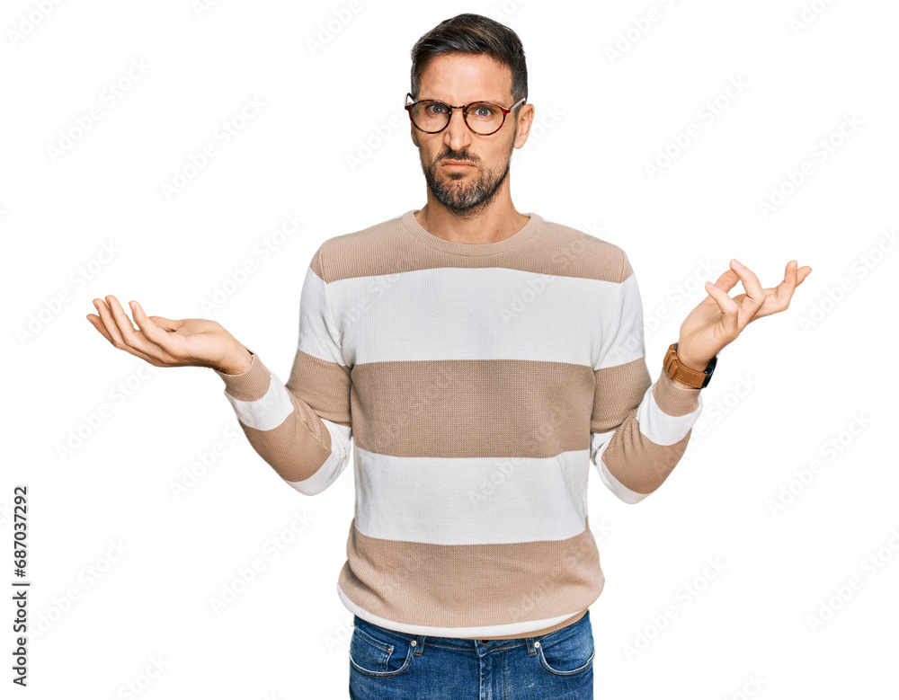 Handsome man with beard wearing casual clothes and glasses clueless and confused with open arms, no idea concept. Handsome man with beard wearing casual clothes and glasses clueless and confused with open arms, no idea concept.