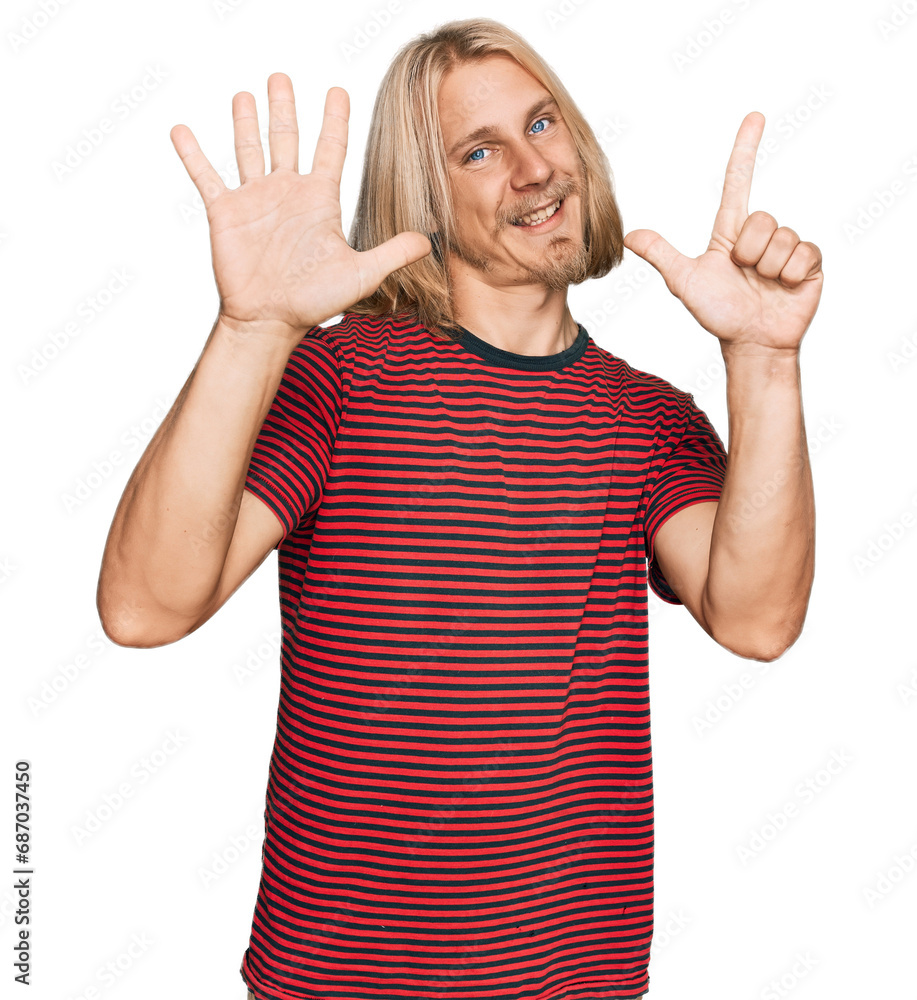 Caucasian man with blond long hair wearing casual striped t shirt showing and pointing up with fingers number seven while smiling confident and happy. Caucasian man with blond long hair wearing casual striped t shirt showing and pointing up with fingers number seven while smiling confident and happy.