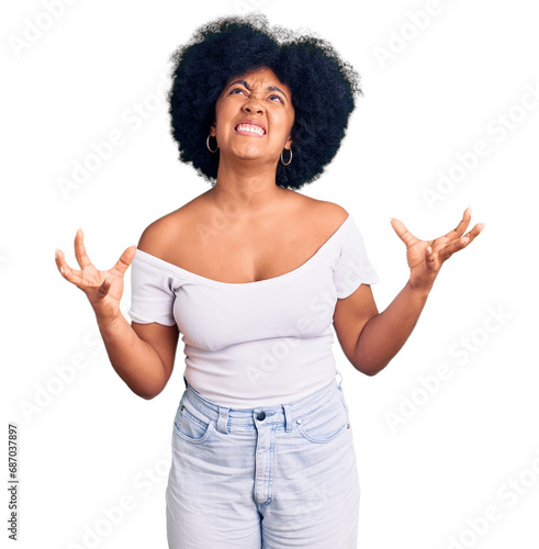 Young african american girl wearing casual clothes crazy and mad shouting and yelling with aggressive expression and arms raised. frustration concept.