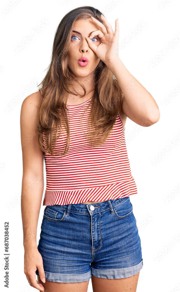 Beautiful caucasian young woman wearing casual clothes doing ok gesture shocked with surprised face, eye looking through fingers. unbelieving expression. Beautiful caucasian young woman wearing casual clothes doing ok gesture shocked with surprised face, eye looking through fingers. unbelieving expression.