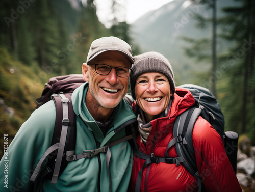 Middle-aged couple hiking in the mountains, enjoying life, retirement, happiness 