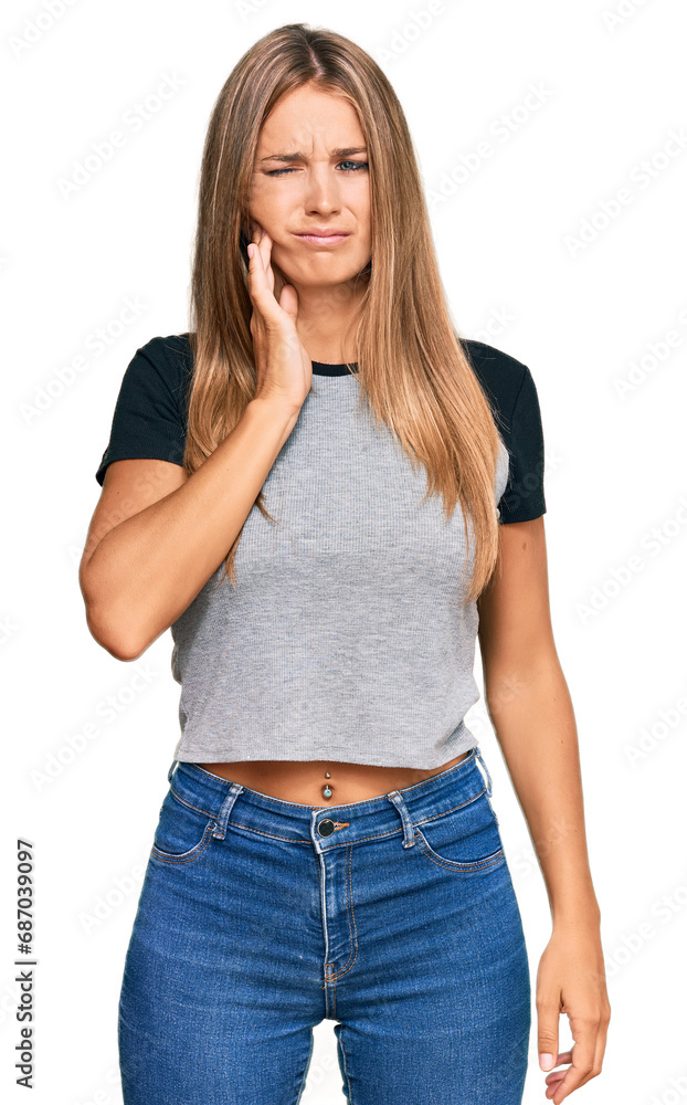 Fototapeta premium Young blonde woman wearing casual clothes touching mouth with hand with painful expression because of toothache or dental illness on teeth. dentist