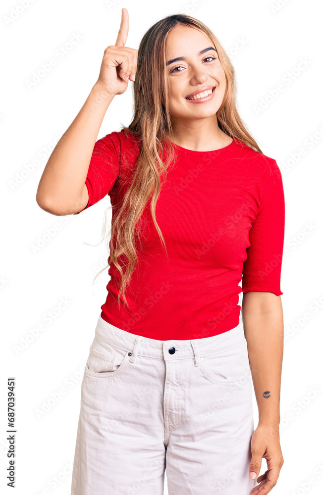 Young beautiful blonde woman wearing casual clothes pointing finger up with successful idea. exited and happy. number one. Young beautiful blonde woman wearing casual clothes pointing finger up with successful idea. exited and happy. number one.