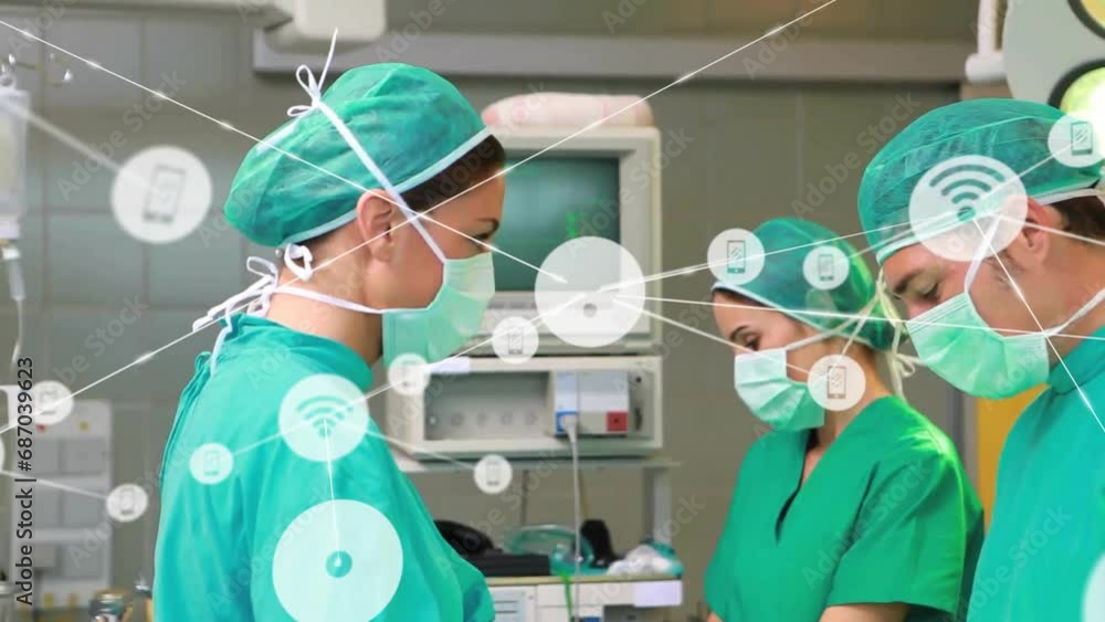 Animation of connected icons over caucasian doctor and medical staff performing surgery Animation of connected icons over caucasian doctor and medical staff performing surgery