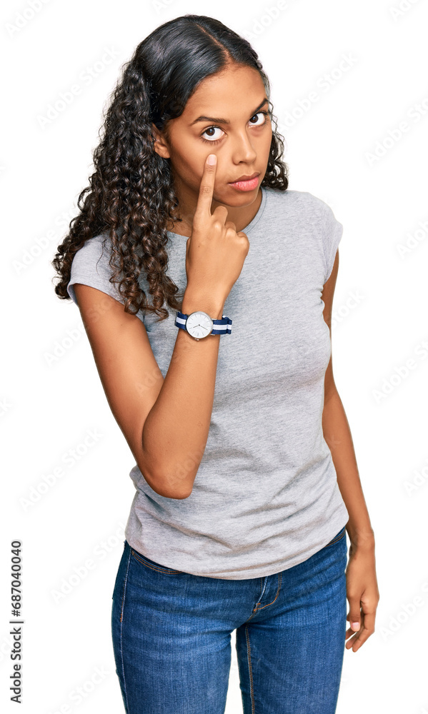 Young african american girl wearing casual clothes pointing to the eye watching you gesture, suspicious expression Young african american girl wearing casual clothes pointing to the eye watching you gesture, suspicious expression