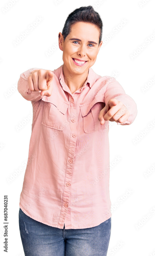Young woman with short hair wearing casual clothes pointing to you and the camera with fingers, smiling positive and cheerful Young woman with short hair wearing casual clothes pointing to you and the camera with fingers, smiling positive and cheerful