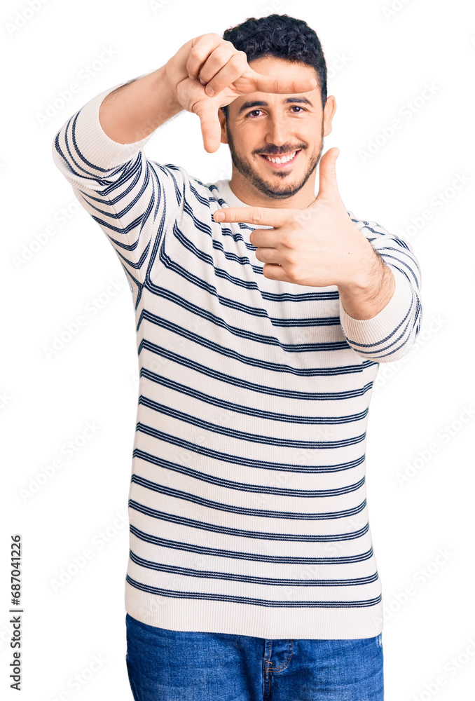 Young hispanic man wearing casual clothes smiling making frame with hands and fingers with happy face. creativity and photography concept. Young hispanic man wearing casual clothes smiling making frame with hands and fingers with happy face. creativity and photography concept.