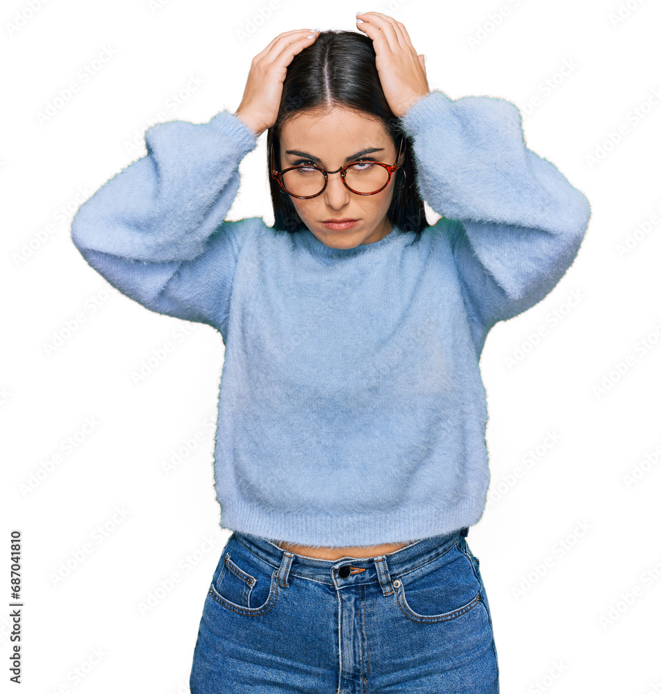 Young hispanic woman wearing casual clothes and glasses suffering from headache desperate and stressed because pain and migraine. hands on head. Young hispanic woman wearing casual clothes and glasses suffering from headache desperate and stressed because pain and migraine. hands on head.
