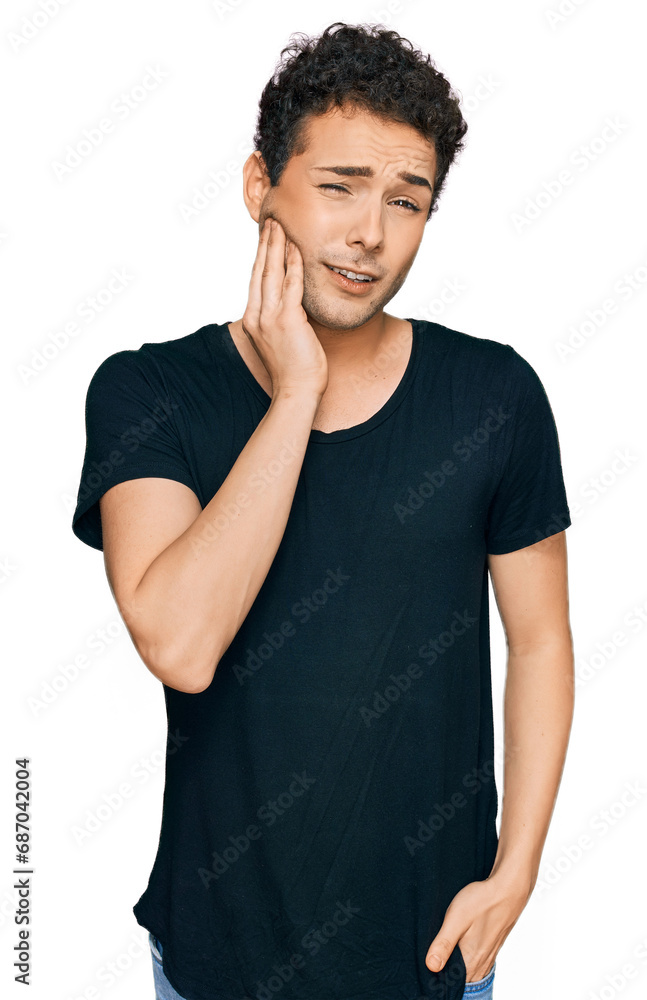 Young handsome man wearing casual black t shirt touching mouth with hand with painful expression because of toothache or dental illness on teeth. dentist Young handsome man wearing casual black t shirt touching mouth with hand with painful expression because of toothache or dental illness on teeth. dentist