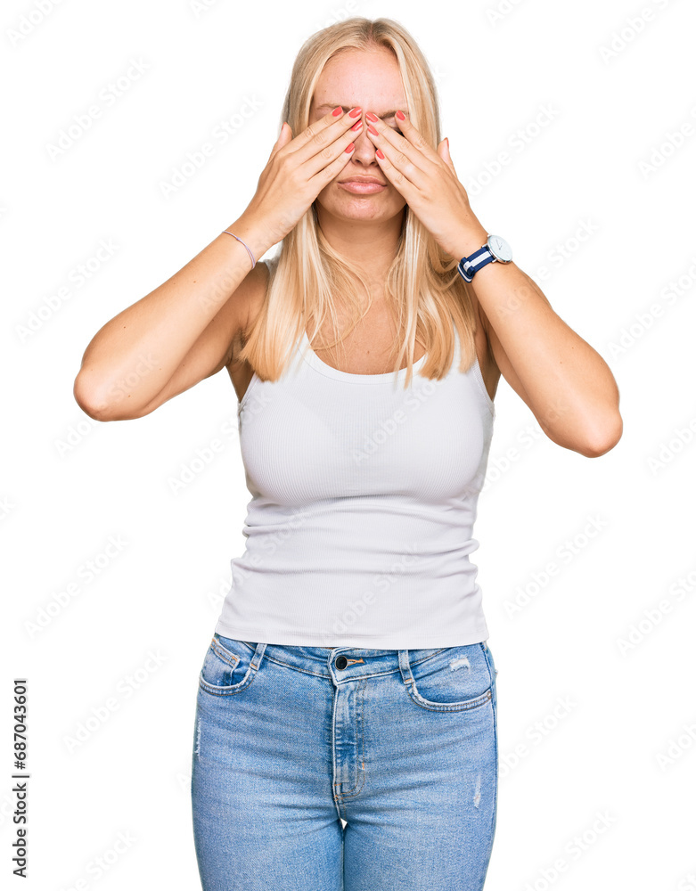 Young blonde girl wearing casual style with sleeveless shirt rubbing eyes for fatigue and headache, sleepy and tired expression. vision problem Young blonde girl wearing casual style with sleeveless shirt rubbing eyes for fatigue and headache, sleepy and tired expression. vision problem