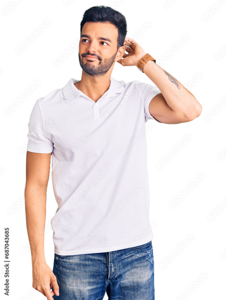 Young handsome hispanic man wearing casual clothes confuse and wondering about question. uncertain with doubt, thinking with hand on head. pensive concept. Young handsome hispanic man wearing casual clothes confuse and wondering about question. uncertain with doubt, thinking with hand on head. pensive concept.