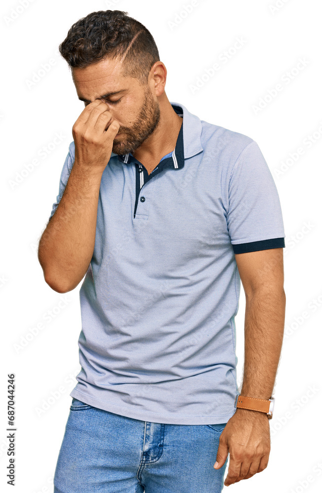 Handsome man with beard wearing casual clothes tired rubbing nose and eyes feeling fatigue and headache. stress and frustration concept. Handsome man with beard wearing casual clothes tired rubbing nose and eyes feeling fatigue and headache. stress and frustration concept.