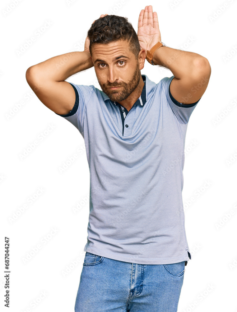 Handsome man with beard wearing casual clothes doing bunny ears gesture with hands palms looking cynical and skeptical. easter rabbit concept. Handsome man with beard wearing casual clothes doing bunny ears gesture with hands palms looking cynical and skeptical. easter rabbit concept.