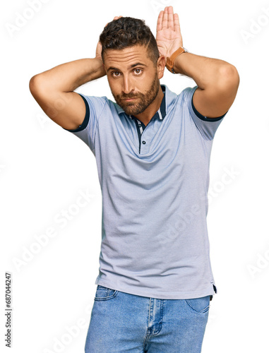 Handsome man with beard wearing casual clothes doing bunny ears gesture with hands palms looking cynical and skeptical. easter rabbit concept.