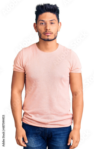 Handsome latin american young man wearing casual clothes with serious expression on face. simple and natural looking at the camera.