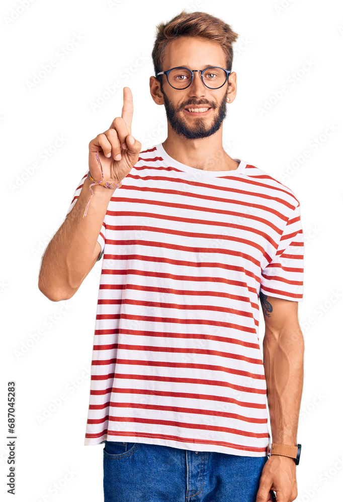 Handsome blond man with beard wearing casual clothes and glasses pointing finger up with successful idea. exited and happy. number one. Handsome blond man with beard wearing casual clothes and glasses pointing finger up with successful idea. exited and happy. number one.