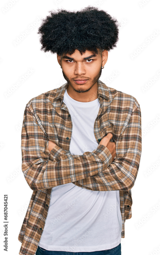 Young african american man with afro hair wearing casual clothes skeptic and nervous, disapproving expression on face with crossed arms. negative person. Young african american man with afro hair wearing casual clothes skeptic and nervous, disapproving expression on face with crossed arms. negative person.