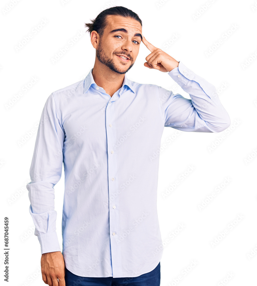 Young handsome man wearing business clothes smiling pointing to head with one finger, great idea or thought, good memory Young handsome man wearing business clothes smiling pointing to head with one finger, great idea or thought, good memory