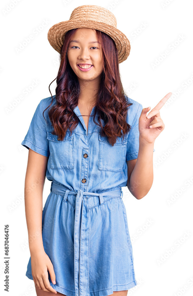 Young beautiful chinese girl wearing summer hat with a big smile on face, pointing with hand finger to the side looking at the camera. Young beautiful chinese girl wearing summer hat with a big smile on face, pointing with hand finger to the side looking at the camera.