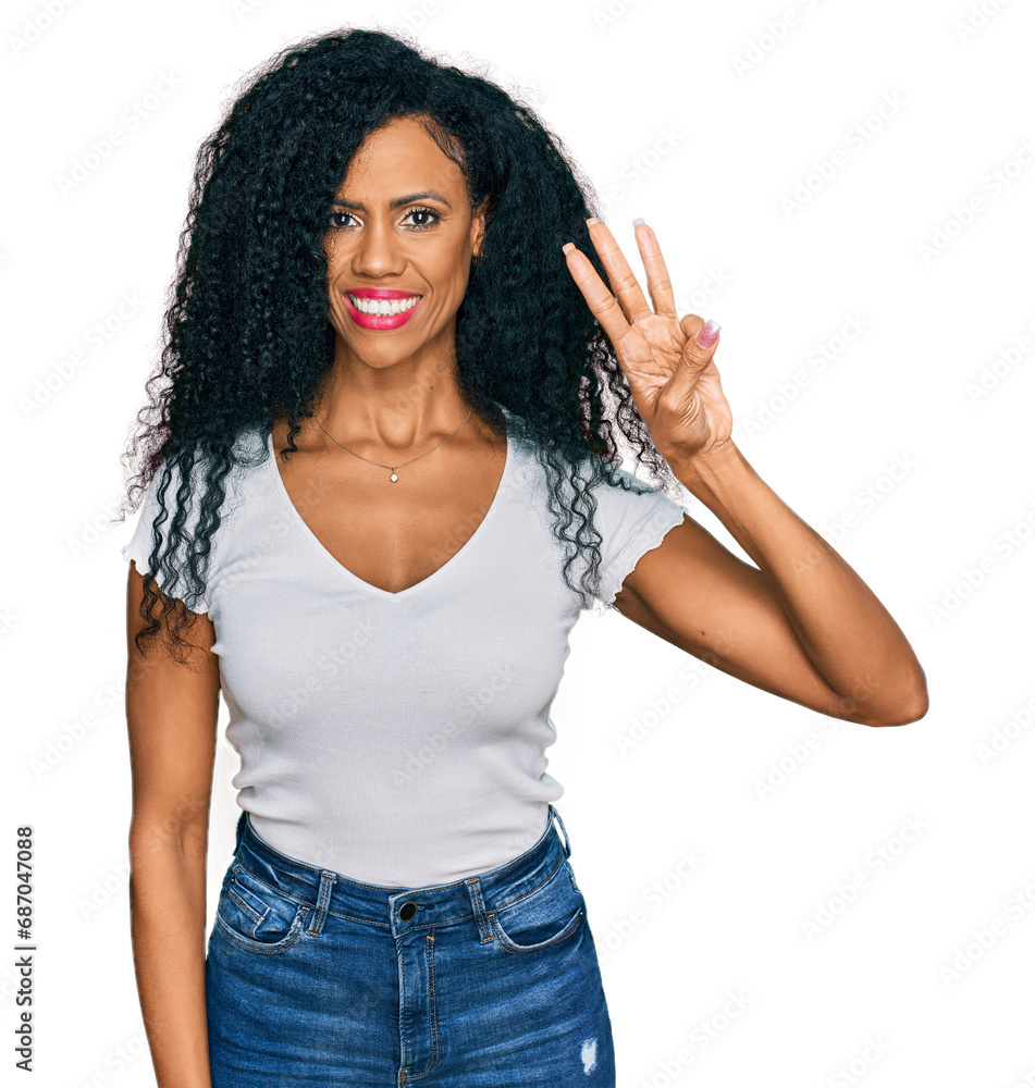 Middle age african american woman wearing casual white t shirt showing and pointing up with fingers number three while smiling confident and happy. Middle age african american woman wearing casual white t shirt showing and pointing up with fingers number three while smiling confident and happy.