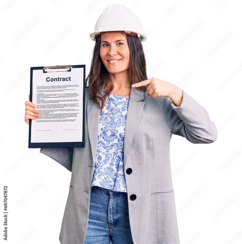 Young beautiful brunette woman wearing architect hardhat holding contract pointing finger to one self smiling happy and proud
