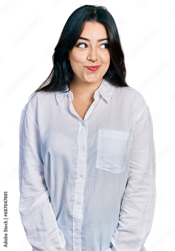 Beautiful hispanic woman wearing casual white shirt smiling looking to the side and staring away thinking. Beautiful hispanic woman wearing casual white shirt smiling looking to the side and staring away thinking.