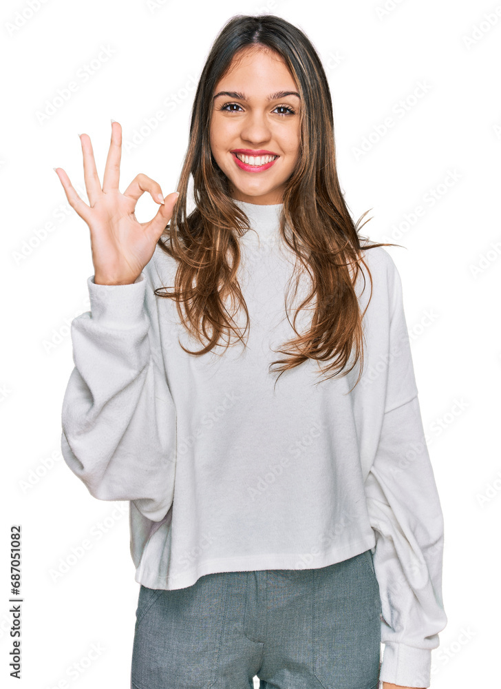 Young brunette woman wearing casual turtleneck sweater smiling positive doing ok sign with hand and fingers. successful expression. Young brunette woman wearing casual turtleneck sweater smiling positive doing ok sign with hand and fingers. successful expression.