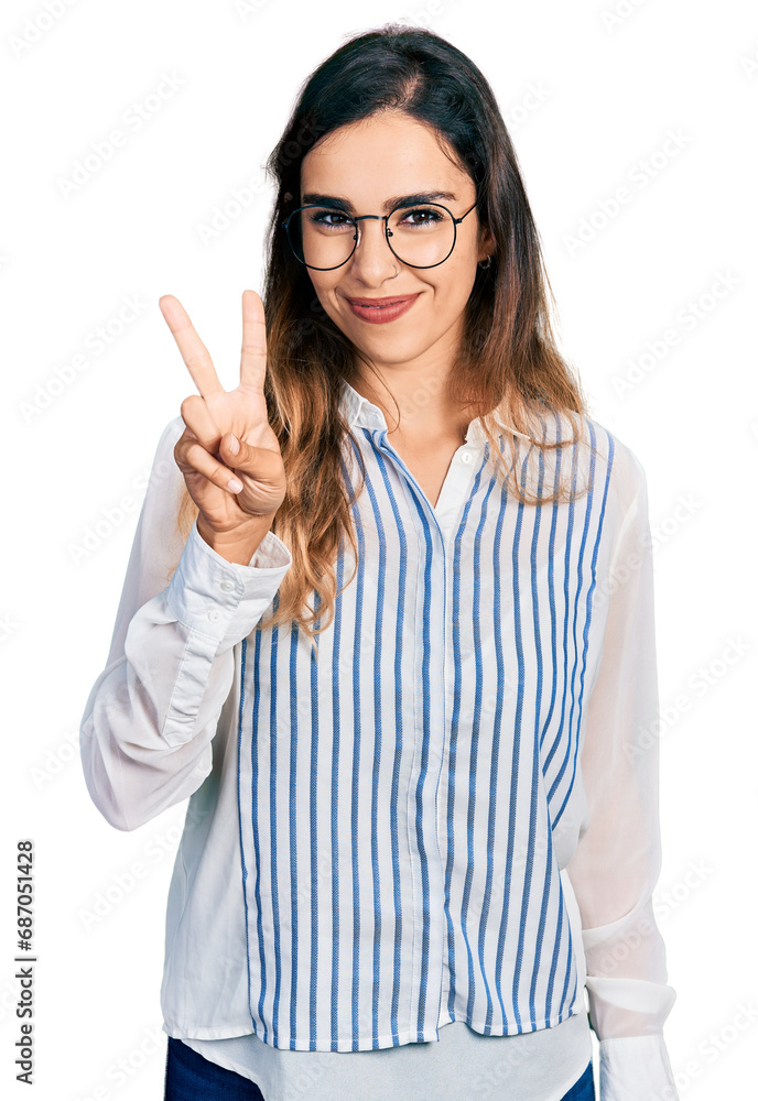 Beautiful hispanic woman wearing casual striped shirt showing and pointing up with fingers number two while smiling confident and happy. Beautiful hispanic woman wearing casual striped shirt showing and pointing up with fingers number two while smiling confident and happy.
