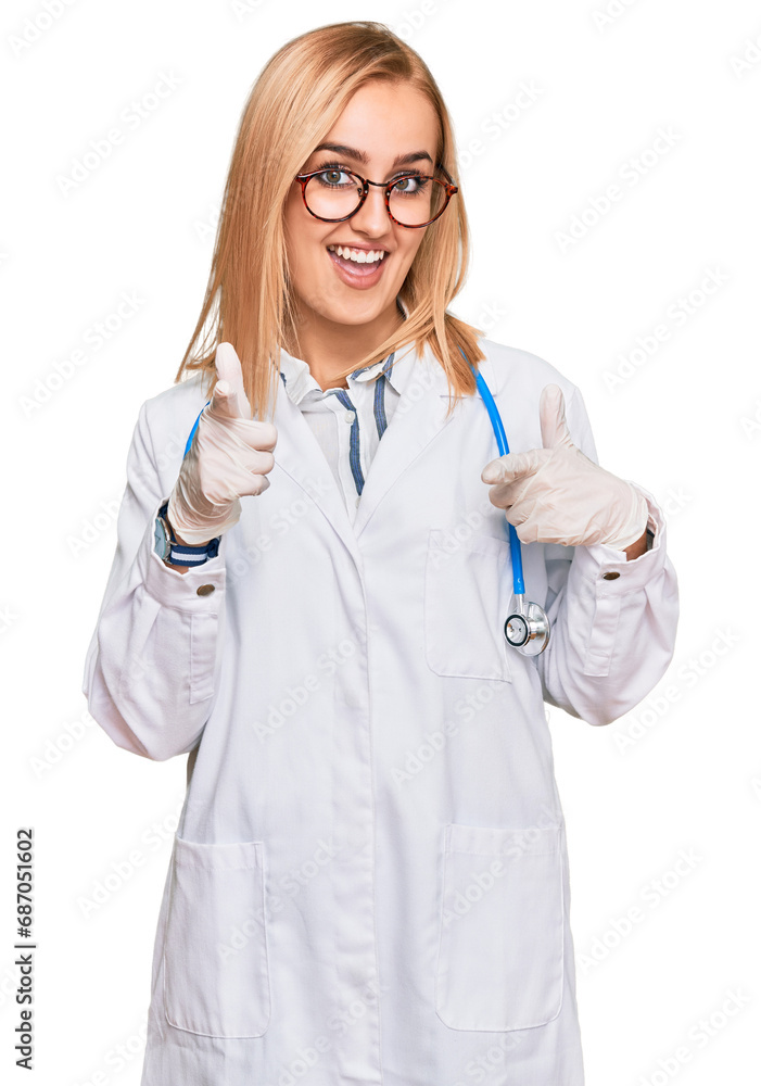 Beautiful caucasian woman wearing doctor uniform and stethoscope pointing fingers to camera with happy and funny face. good energy and vibes. Beautiful caucasian woman wearing doctor uniform and stethoscope pointing fingers to camera with happy and funny face. good energy and vibes.