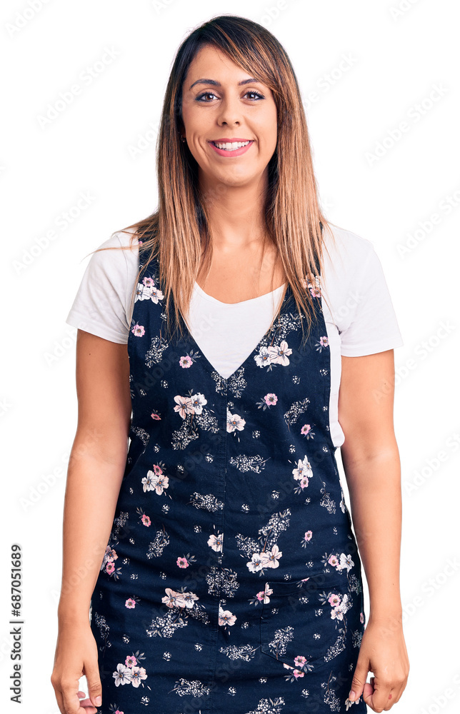 Young beautiful woman wearing casual floral dress looking positive and happy standing and smiling with a confident smile showing teeth Young beautiful woman wearing casual floral dress looking positive and happy standing and smiling with a confident smile showing teeth