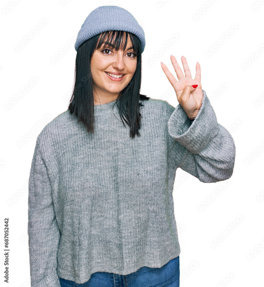 Young hispanic woman wearing cute wool cap showing and pointing up with fingers number four while smiling confident and happy. Young hispanic woman wearing cute wool cap showing and pointing up with fingers number four while smiling confident and happy.