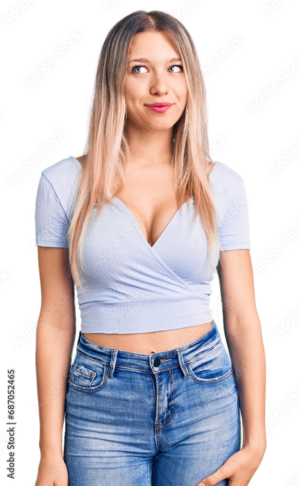 Young beautiful blonde woman wearing casual clothes smiling looking to the side and staring away thinking. Young beautiful blonde woman wearing casual clothes smiling looking to the side and staring away thinking.