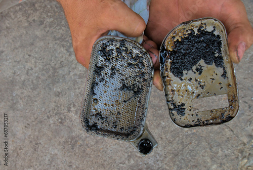 Heavily contaminated oil intake pipe from a car engine, quality service and oils for cars