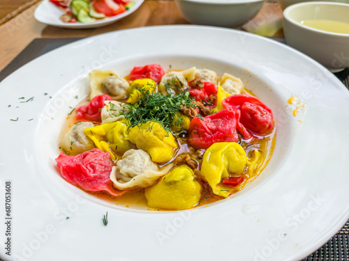 Colored dumplings are on a plate in a restaurant. Food for children