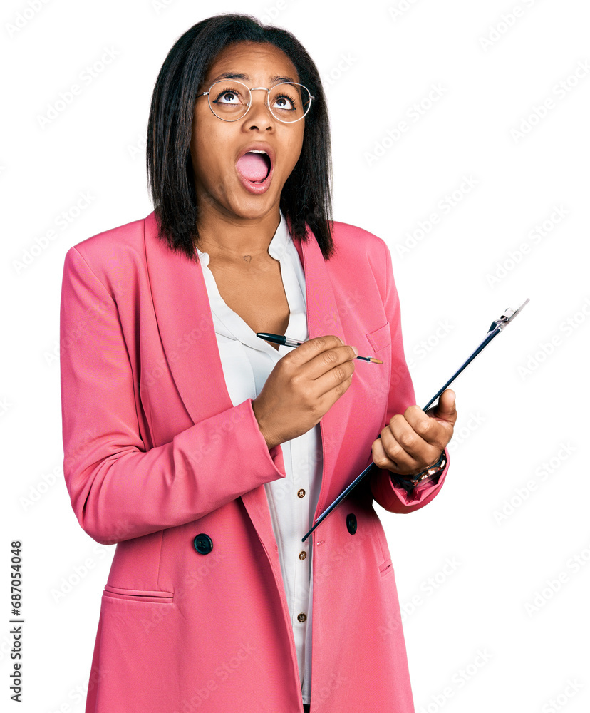 Beautiful hispanic woman holding clipboard angry and mad screaming frustrated and furious, shouting with anger looking up. Beautiful hispanic woman holding clipboard angry and mad screaming frustrated and furious, shouting with anger looking up.