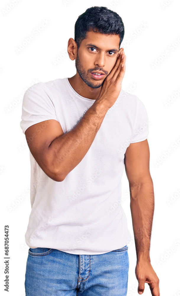 Young latin man wearing casual clothes hand on mouth telling secret rumor, whispering malicious talk conversation Young latin man wearing casual clothes hand on mouth telling secret rumor, whispering malicious talk conversation