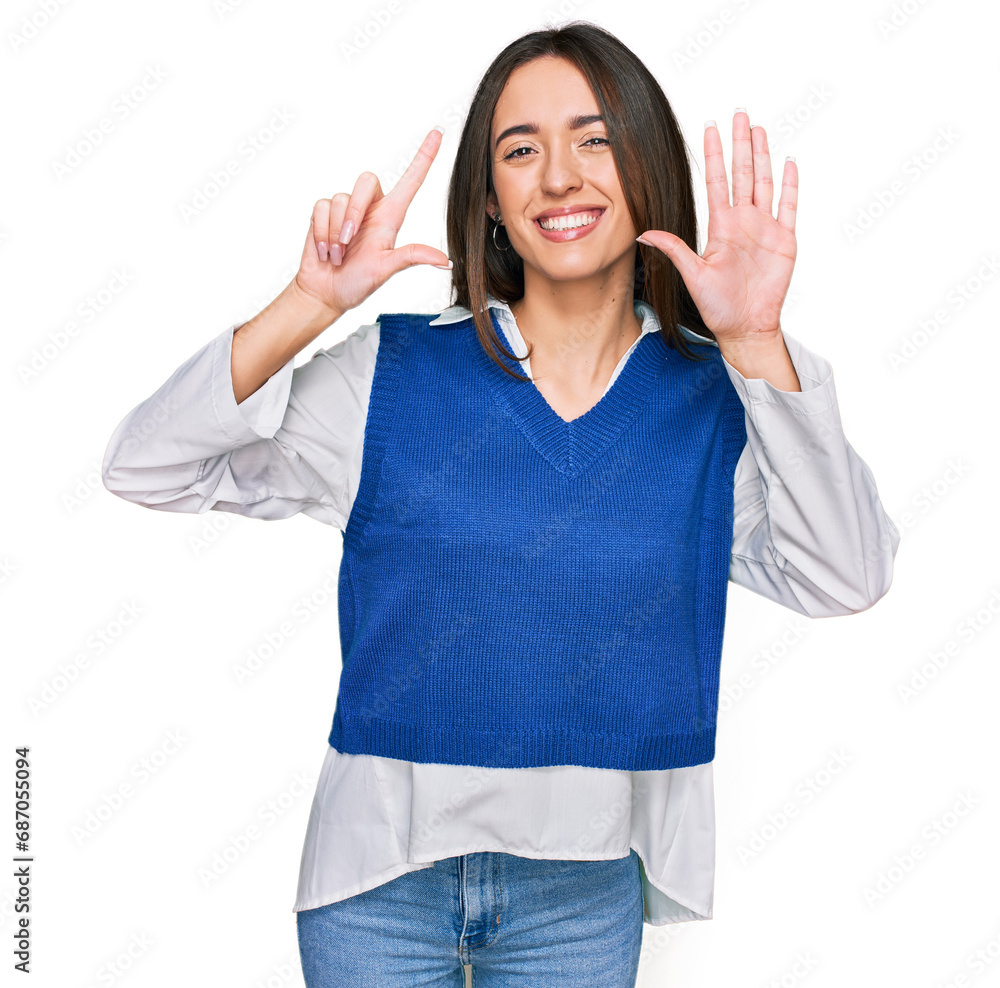 Young hispanic girl wearing casual clothes showing and pointing up with fingers number seven while smiling confident and happy. Young hispanic girl wearing casual clothes showing and pointing up with fingers number seven while smiling confident and happy.