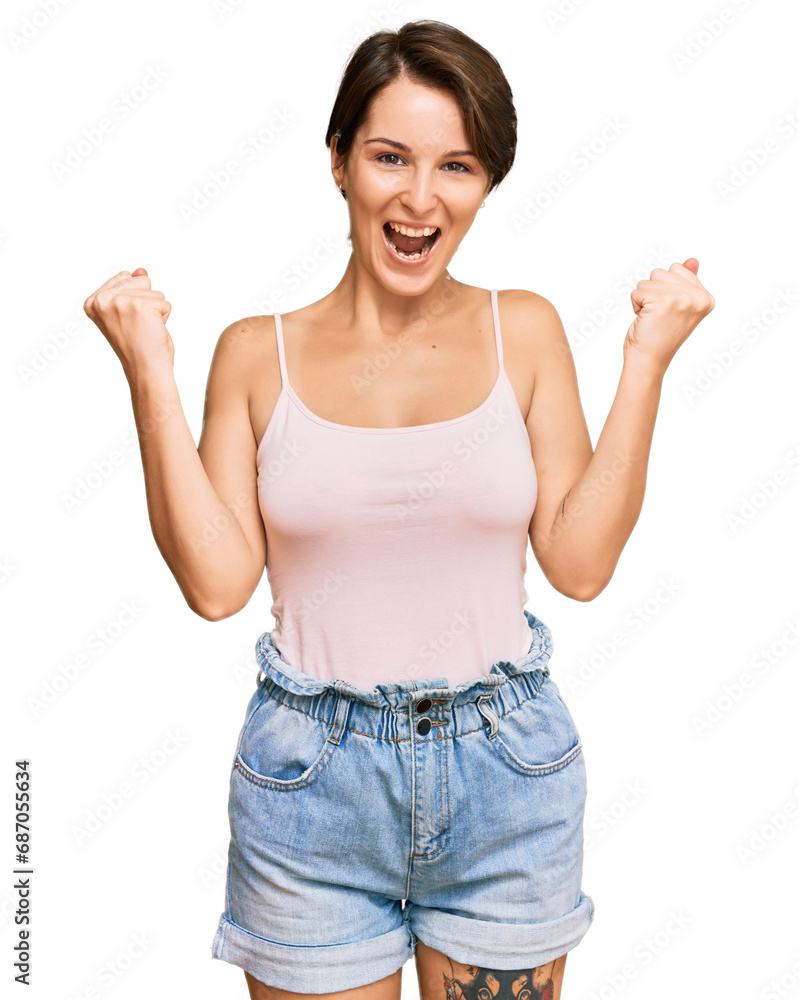 Young brunette woman with short hair wearing casual summer clothes screaming proud, celebrating victory and success very excited with raised arms Young brunette woman with short hair wearing casual summer clothes screaming proud, celebrating victory and success very excited with raised arms