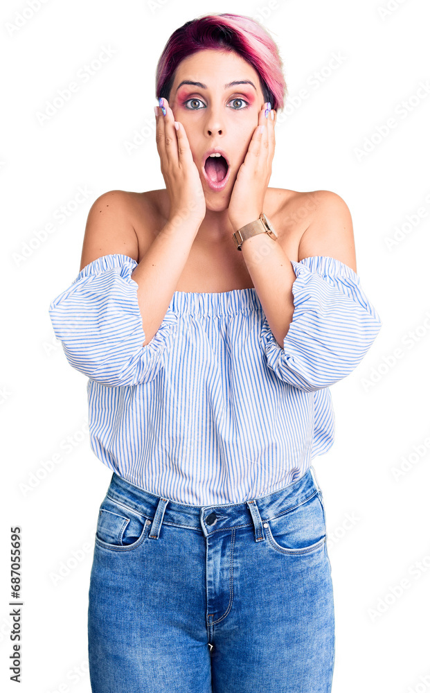 Young beautiful woman with pink hair wearing casual clothes afraid and shocked, surprise and amazed expression with hands on face Young beautiful woman with pink hair wearing casual clothes afraid and shocked, surprise and amazed expression with hands on face