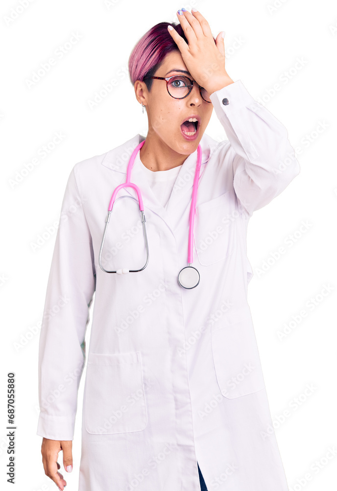 Young beautiful woman with pink hair wearing doctor uniform surprised with hand on head for mistake, remember error. forgot, bad memory concept. Young beautiful woman with pink hair wearing doctor uniform surprised with hand on head for mistake, remember error. forgot, bad memory concept.