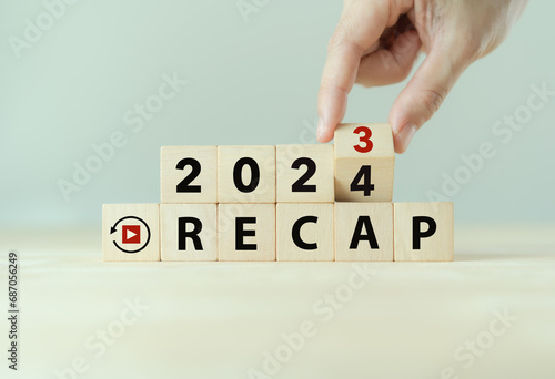 2023 Recap economy, business, financial concept. Business plan in 2024. RECAP words and 2023, 2024 on wooden cubes on smart grey background and copy space.